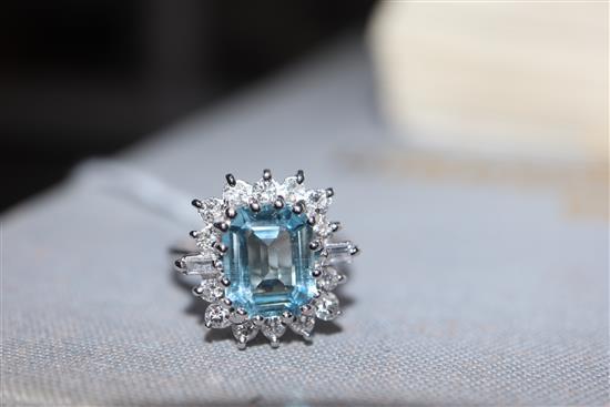 A modern 18ct white metal, aquamarine, baguette and round cut diamond set cluster ring, size K/L.